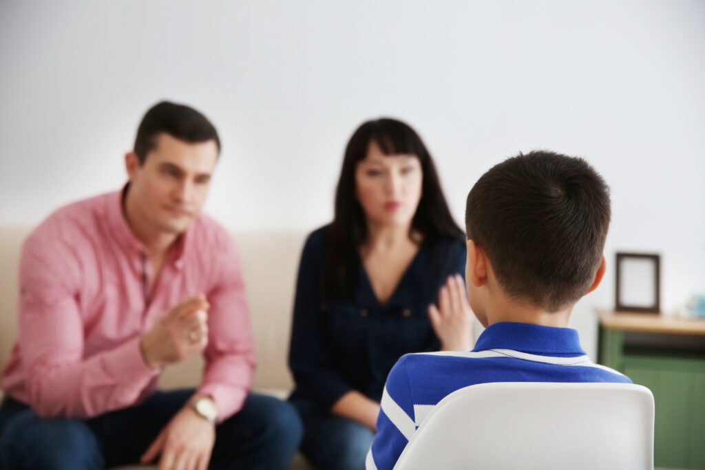 Parents berating their son indoors